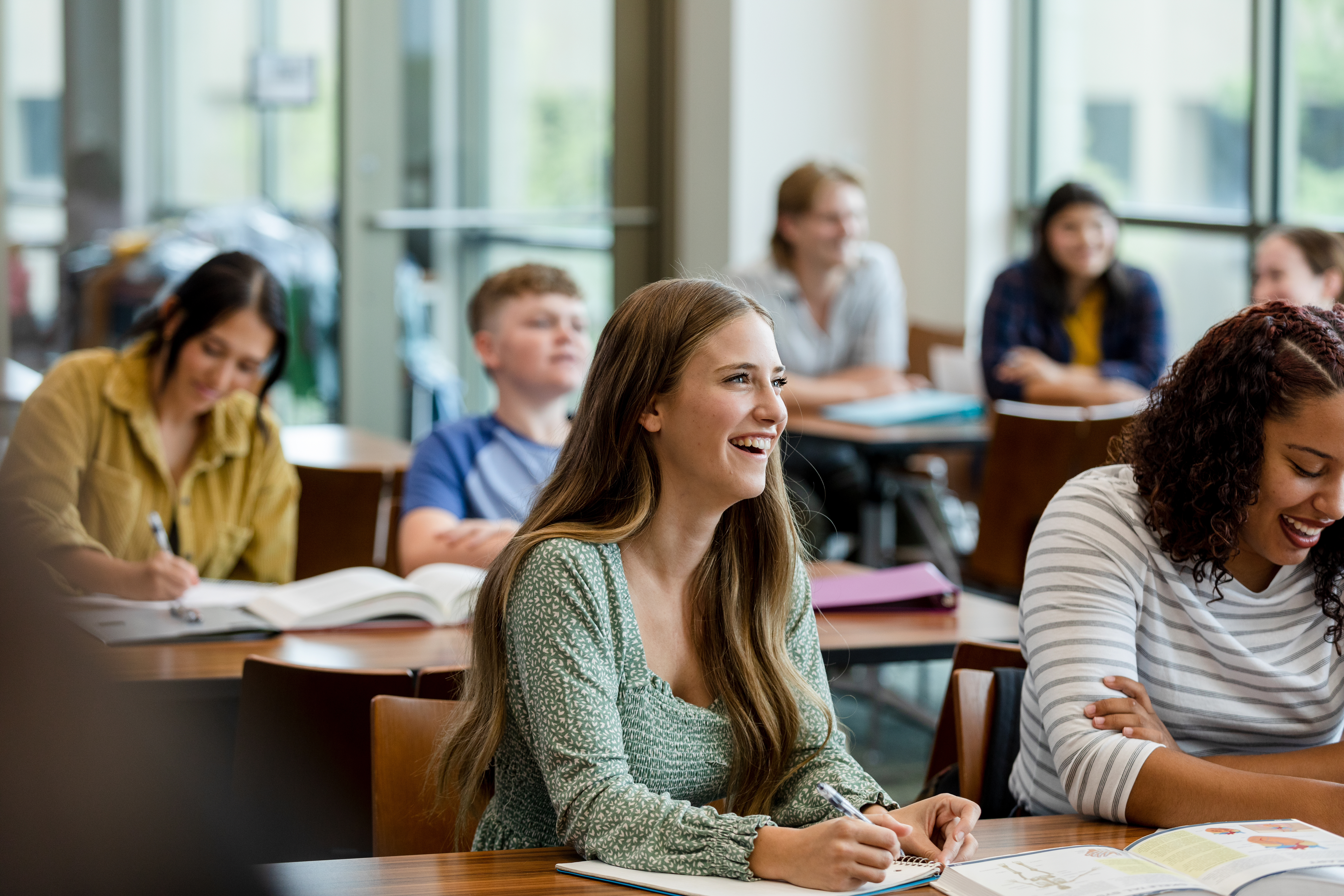 College students taking notes during class